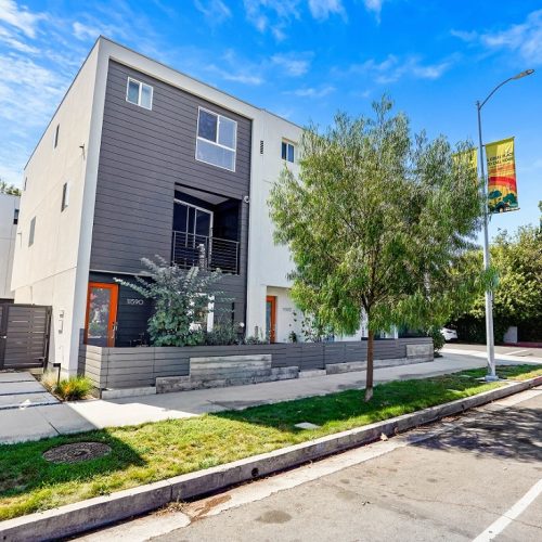 Modern three-story townhouse in Sherman Oaks exterior with black facade and landscaped frontage.